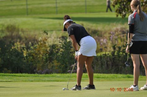 Camryn Jones during the IHSA Sectionals meet, lining up to hit the ball