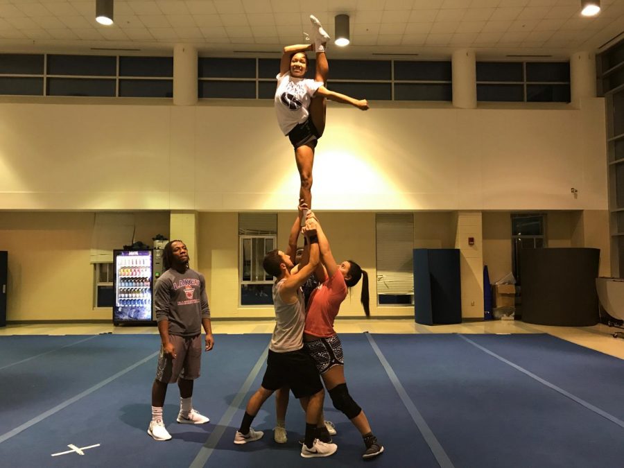 The cheer team practicing their stunts at practice