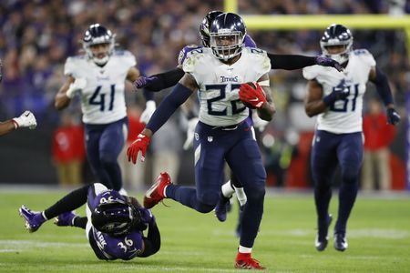 Derrick Henry rushing down the field after breaking a tackle. 