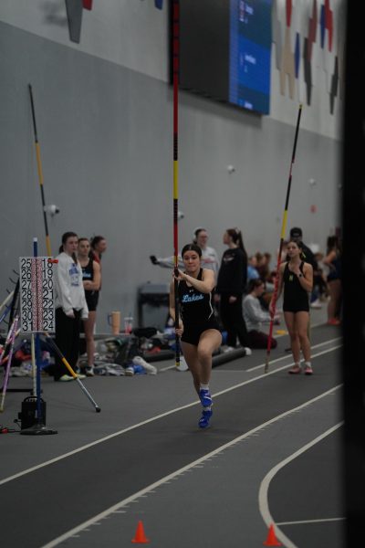 Senior Isabella Aya starts her pole vault.